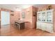 Dining area with a long wooden table and a white china cabinet at 4944 E Windrose Dr, Scottsdale, AZ 85254