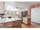 Kitchen with white cabinets, a brick breakfast bar, and stainless steel appliances at 4944 E Windrose Dr, Scottsdale, AZ 85254