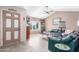 Living room with a green sectional sofa, and tile floors at 4944 E Windrose Dr, Scottsdale, AZ 85254