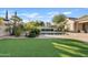 Artificial turf and lush landscaping create a serene backyard at 5045 S Mingus Pl, Chandler, AZ 85249