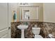 Small bathroom with pedestal sink and decorative tile at 5045 S Mingus Pl, Chandler, AZ 85249