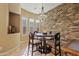 Bright breakfast nook boasts a stone feature wall and a round dining table at 5045 S Mingus Pl, Chandler, AZ 85249