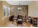 Charming breakfast nook with stone accent wall and wood furniture at 5045 S Mingus Pl, Chandler, AZ 85249