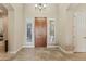 Elegant entryway with a rich wood door, tile flooring, and a chandelier at 5045 S Mingus Pl, Chandler, AZ 85249