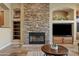 Living room fireplace with stone surround and built-in shelving at 5045 S Mingus Pl, Chandler, AZ 85249