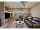 Relaxing living room with leather furniture, fireplace and large windows at 5045 S Mingus Pl, Chandler, AZ 85249