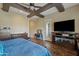 Main bedroom with fireplace, TV, and wood flooring at 5045 S Mingus Pl, Chandler, AZ 85249