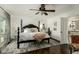 Spacious bedroom with a black poster bed, ceiling fan, and ensuite bathroom at 6318 N 14Th St, Phoenix, AZ 85014