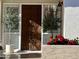 Inviting entryway with a unique, ornate wooden door and lush landscaping at 6318 N 14Th St, Phoenix, AZ 85014