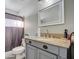 Bathroom with granite vanity and white framed mirror at 6355 W Caron St, Glendale, AZ 85302