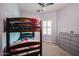 Bedroom with a bunk bed, dresser, and window with shutters at 7008 W Cesar St, Peoria, AZ 85345