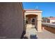 Front entry with a wooden door and a covered porch at 7008 W Cesar St, Peoria, AZ 85345