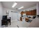 Kitchen features wood cabinets, white appliances, and a dining area at 7008 W Cesar St, Peoria, AZ 85345