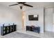 Living room with a TV, shelving, and ceiling fan at 7008 W Cesar St, Peoria, AZ 85345