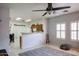 Living room with ceiling fan, large windows, and view of kitchen at 7008 W Cesar St, Peoria, AZ 85345