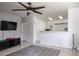 Living room with a ceiling fan and a view of the kitchen at 7008 W Cesar St, Peoria, AZ 85345