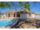 View of home's back with pool and patio at 7101 W Laurel Ln, Peoria, AZ 85345