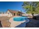 House's backyard features a kidney-shaped pool and patio at 7101 W Laurel Ln, Peoria, AZ 85345