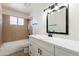 Clean bathroom with white vanity and brown tile at 7101 W Laurel Ln, Peoria, AZ 85345