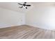 Bright bedroom with vaulted ceiling and wood-look flooring at 7101 W Laurel Ln, Peoria, AZ 85345