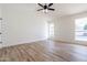 Well-lit bedroom with wood-look floors and ceiling fan at 7101 W Laurel Ln, Peoria, AZ 85345