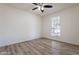 Bright bedroom with large window and ceiling fan at 7101 W Laurel Ln, Peoria, AZ 85345