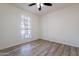 Bright bedroom with large window and ceiling fan at 7101 W Laurel Ln, Peoria, AZ 85345