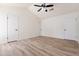 Spacious bedroom featuring wood-look flooring and ceiling fan at 7101 W Laurel Ln, Peoria, AZ 85345