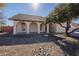 Front view of a single-story house with a gravel driveway and landscaping at 7101 W Laurel Ln, Peoria, AZ 85345