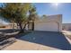 Single-story home with a two-car garage and a well-maintained front yard at 7101 W Laurel Ln, Peoria, AZ 85345