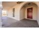 Home's entryway featuring a red door and arched detail at 7101 W Laurel Ln, Peoria, AZ 85345