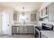 Kitchen with stainless steel appliances and pantry at 7101 W Laurel Ln, Peoria, AZ 85345