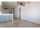 Open concept kitchen with grey cabinets and breakfast bar at 7101 W Laurel Ln, Peoria, AZ 85345