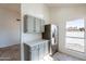 Kitchen with stainless steel appliances and grey cabinets at 7101 W Laurel Ln, Peoria, AZ 85345