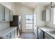 Kitchen with stainless steel appliances and grey cabinets at 7101 W Laurel Ln, Peoria, AZ 85345