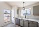 Kitchen with stainless steel appliances and grey cabinets at 7101 W Laurel Ln, Peoria, AZ 85345