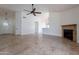 Open living area with a fireplace and neutral tile floors at 7101 W Laurel Ln, Peoria, AZ 85345