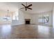 Spacious living room with tile floors, fireplace, and high ceilings at 7101 W Laurel Ln, Peoria, AZ 85345