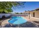 Relaxing kidney-shaped pool in the backyard at 7101 W Laurel Ln, Peoria, AZ 85345