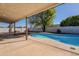 Kidney-shaped pool with surrounding patio and landscaping at 7101 W Laurel Ln, Peoria, AZ 85345