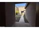 View through a gated passageway to a backyard area at 7309 S 17Th Dr, Phoenix, AZ 85041