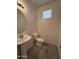 Small bathroom with pedestal sink and toilet at 7309 S 17Th Dr, Phoenix, AZ 85041