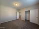 Well-lit bedroom with closet and access to hallway at 7309 S 17Th Dr, Phoenix, AZ 85041