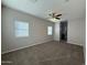 Spacious bedroom with ceiling fan, carpet, and window coverings at 7309 S 17Th Dr, Phoenix, AZ 85041