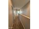 Upper level hallway with neutral paint and carpet at 7309 S 17Th Dr, Phoenix, AZ 85041