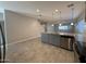 Modern kitchen with gray cabinets, stainless steel appliances, and granite countertops at 7309 S 17Th Dr, Phoenix, AZ 85041