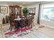 Bright dining room with wood table and large windows at 7813 E Lakeview Ave, Mesa, AZ 85209