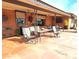 Outdoor patio with seating area, ceiling fans and brick walls at 7813 E Lakeview Ave, Mesa, AZ 85209