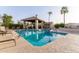 Community pool with lounge chairs and covered patio at 8100 E Camelback Rd # 175, Scottsdale, AZ 85251