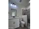 Modern bathroom with white vanity, gray tile shower, and updated fixtures at 8306 W Swansea Dr, Arizona City, AZ 85123